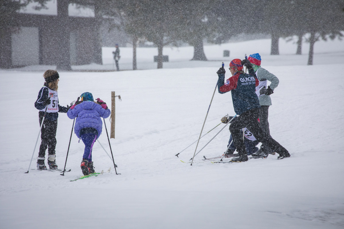 Nordic ski coach talking with racers before the race